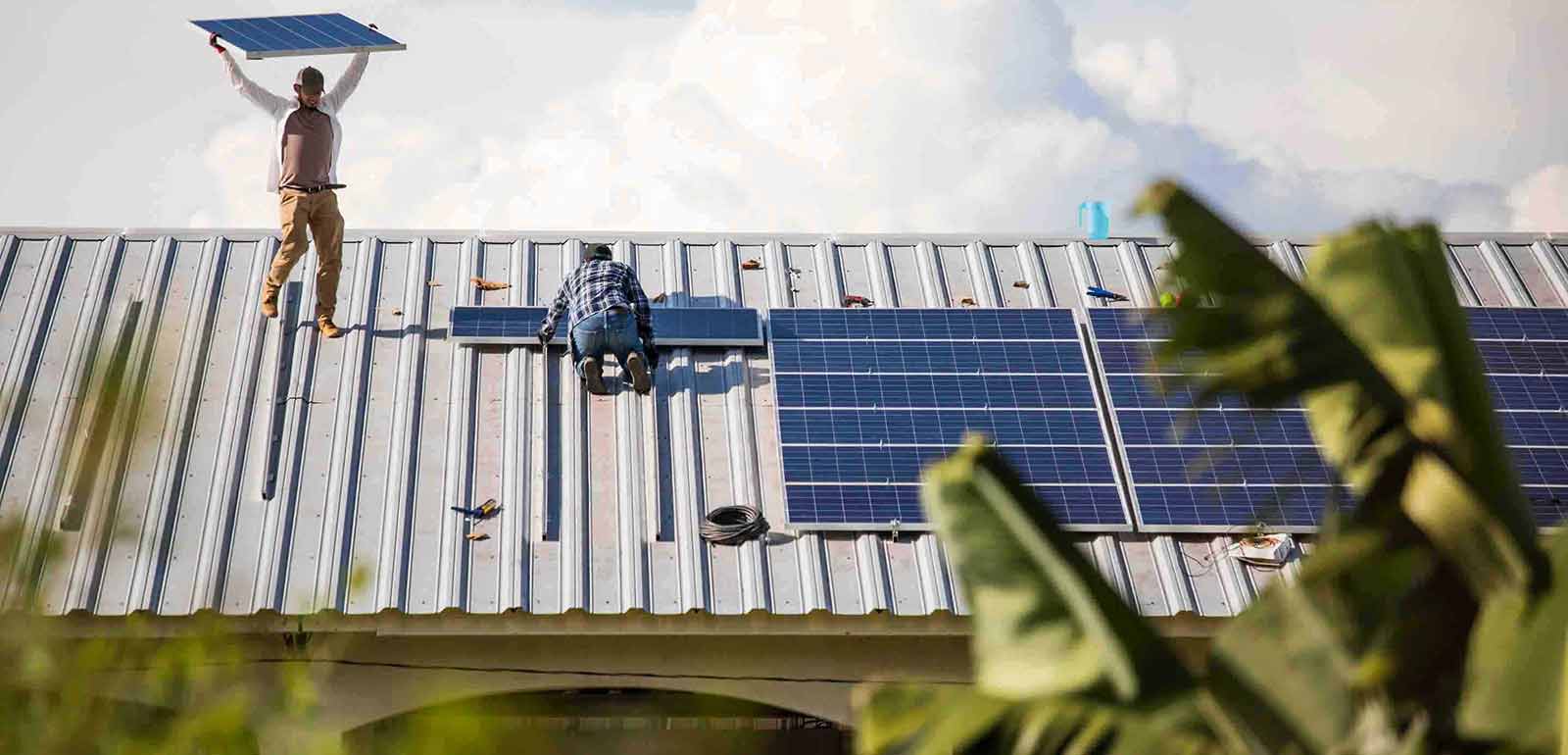 men working on the solar panels at the rooftop